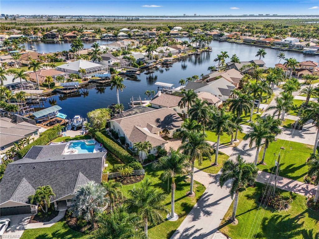 Aerial view of property's location with nearby suburban area and a nearby body of water