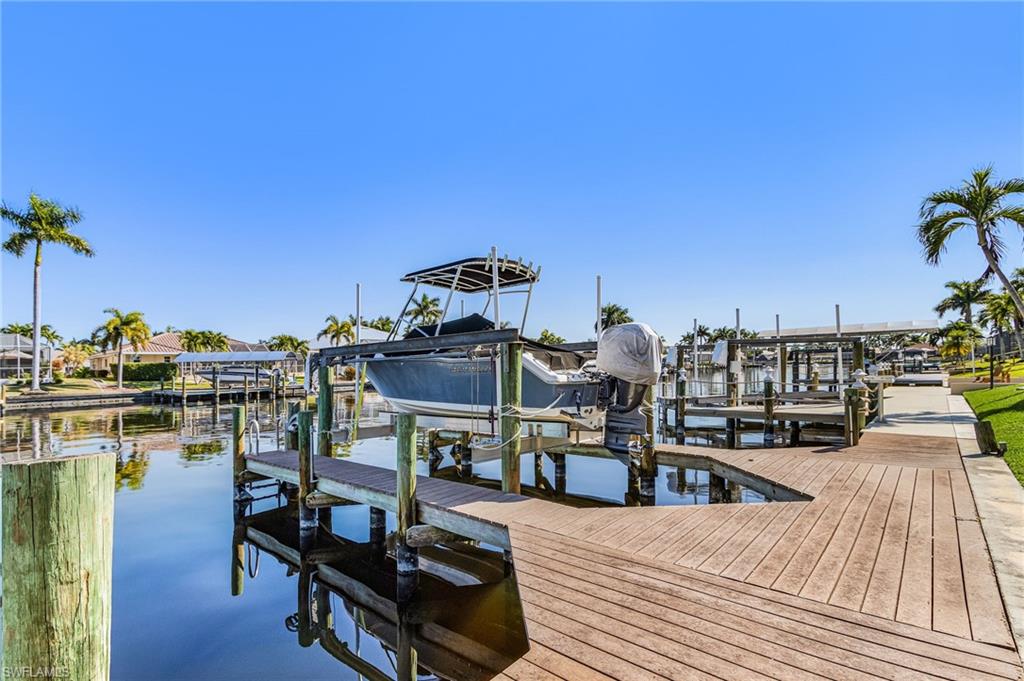Dock featuring boat lift and a water view