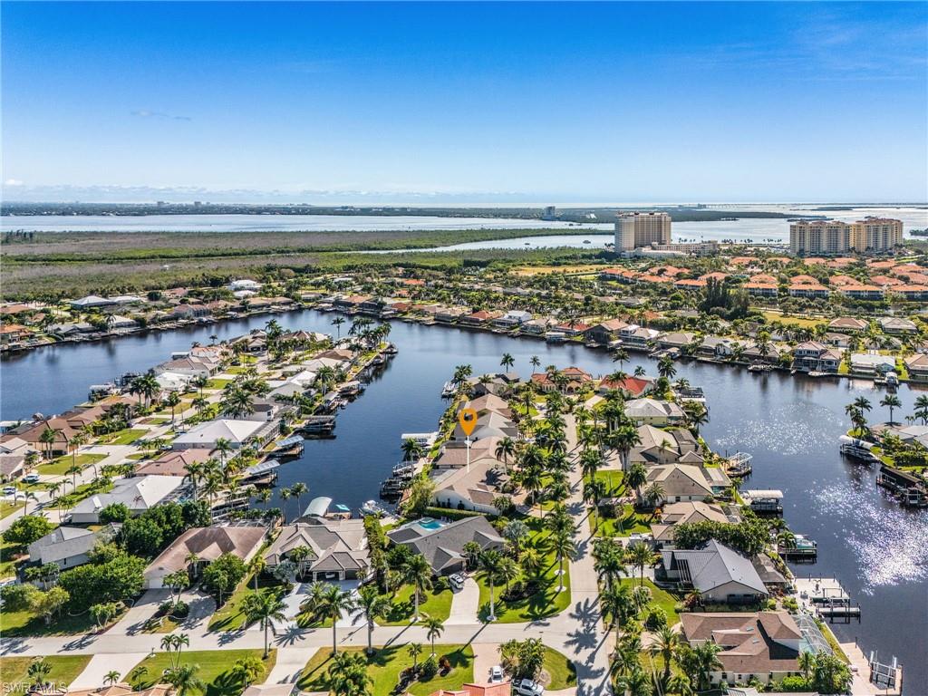 Aerial view of property's location with a large body of water and nearby suburban area