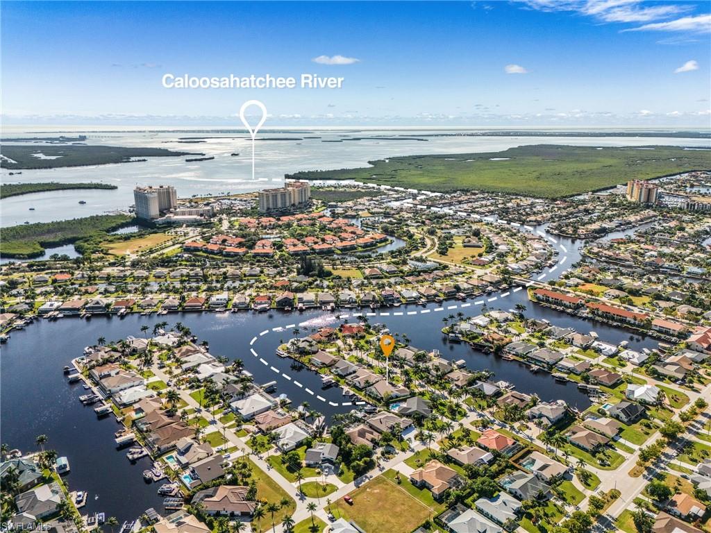 Aerial view of property's location with a nearby body of water and nearby suburban area