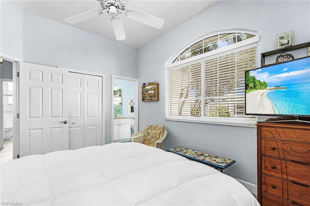 Bedroom featuring ensuite bath, a closet, and ceiling fan