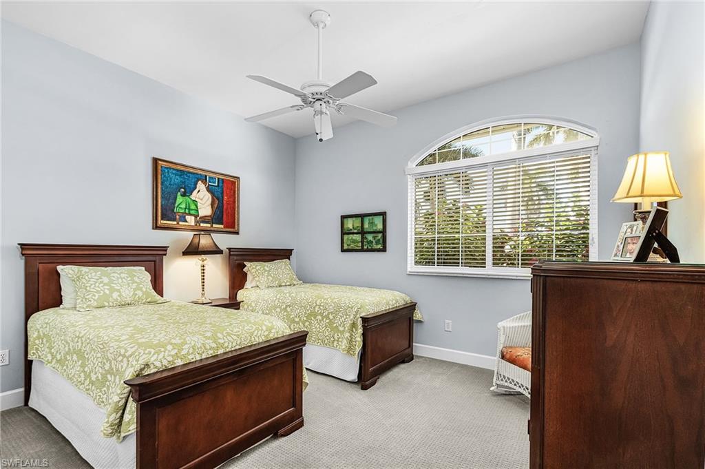 Carpeted bedroom with baseboards and a ceiling fan