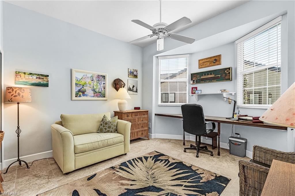 Office with ceiling fan and baseboards