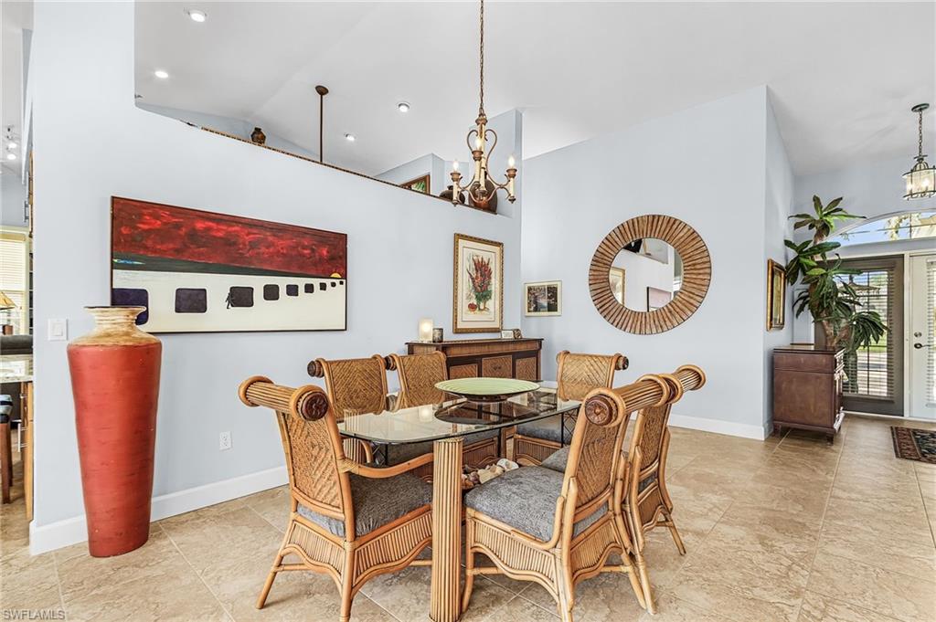 Dining area with a chandelier and high vaulted ceiling
