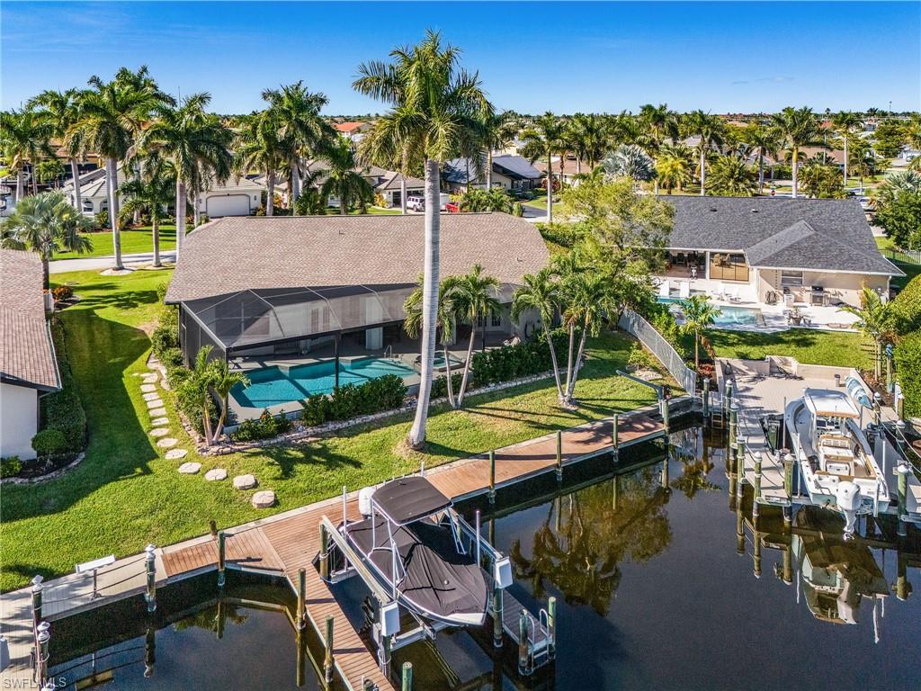 Aerial view of residential area with a pool area and a large body of water