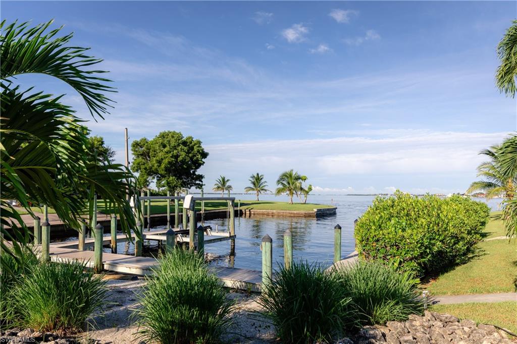 Dock featuring boat lift and a water view