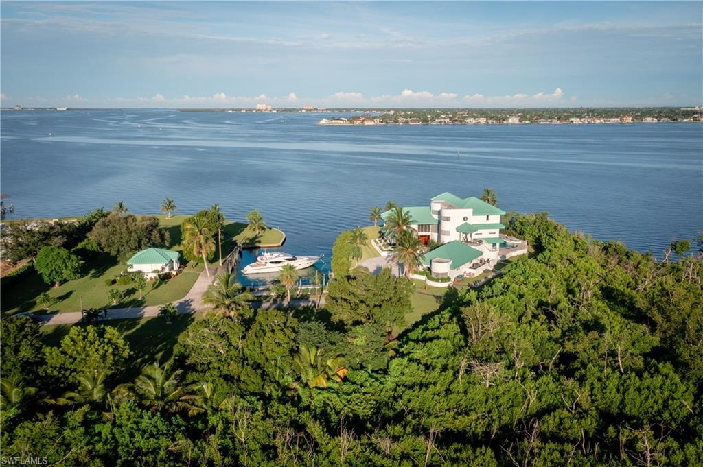 Aerial view of property and surrounding area with a large body of water