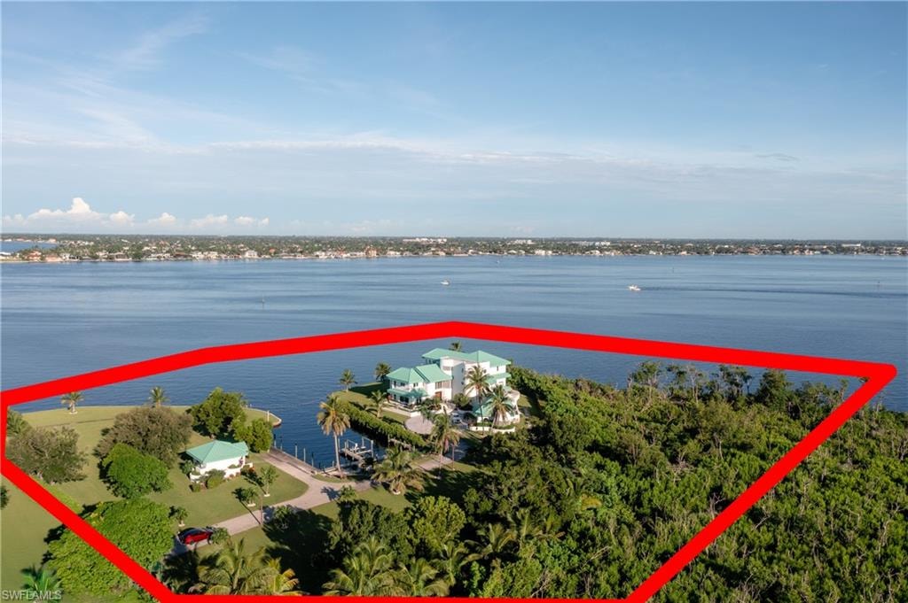 Aerial view of property's location featuring a nearby body of water and property parcel outlined