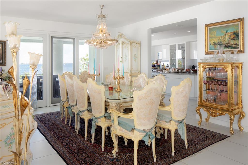 Dining area featuring light tile patterned floors and a chandelier