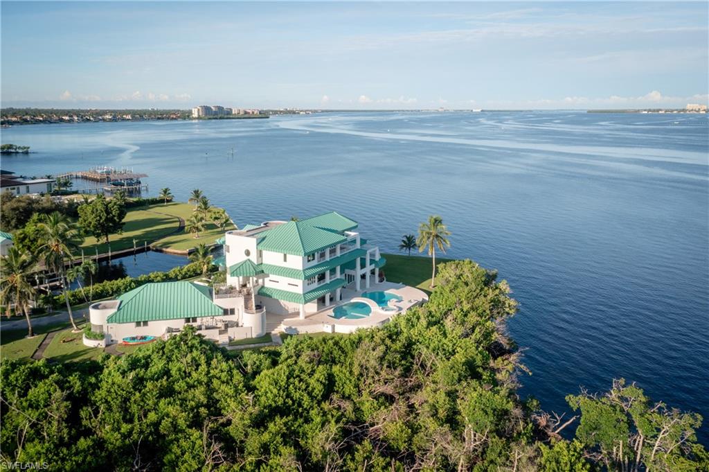View from above of property with a large body of water and a pool