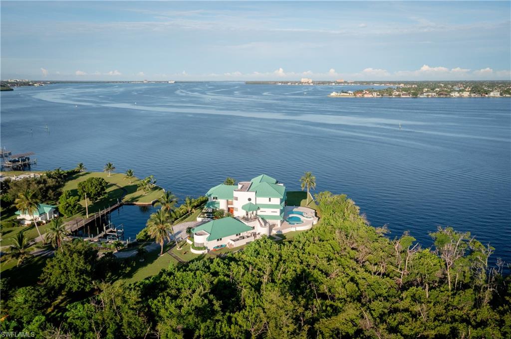 Aerial view of property and surrounding area with a large body of water