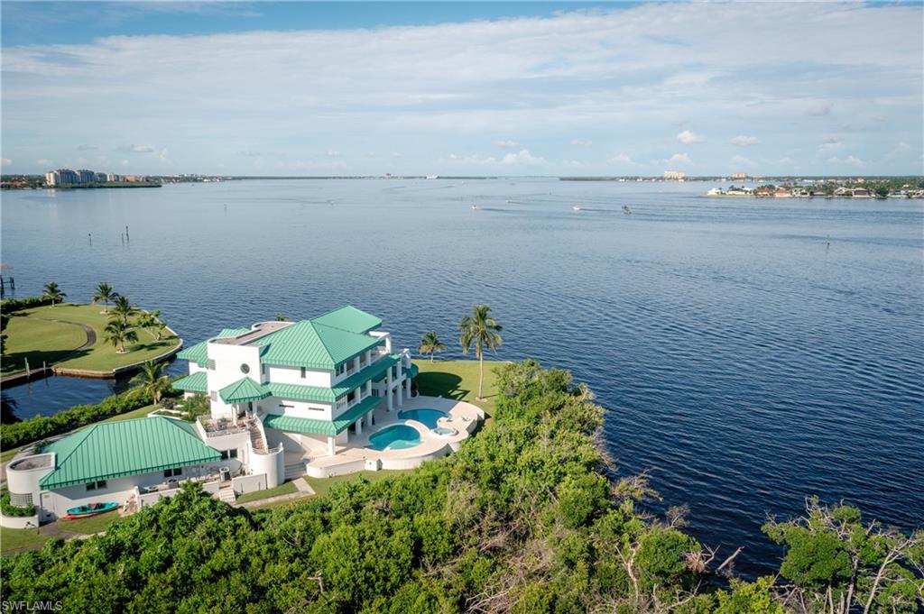 Bird's eye view of a nearby body of water and a pool area