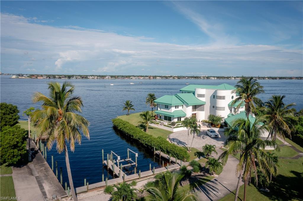 Water view featuring boat lift and a dock
