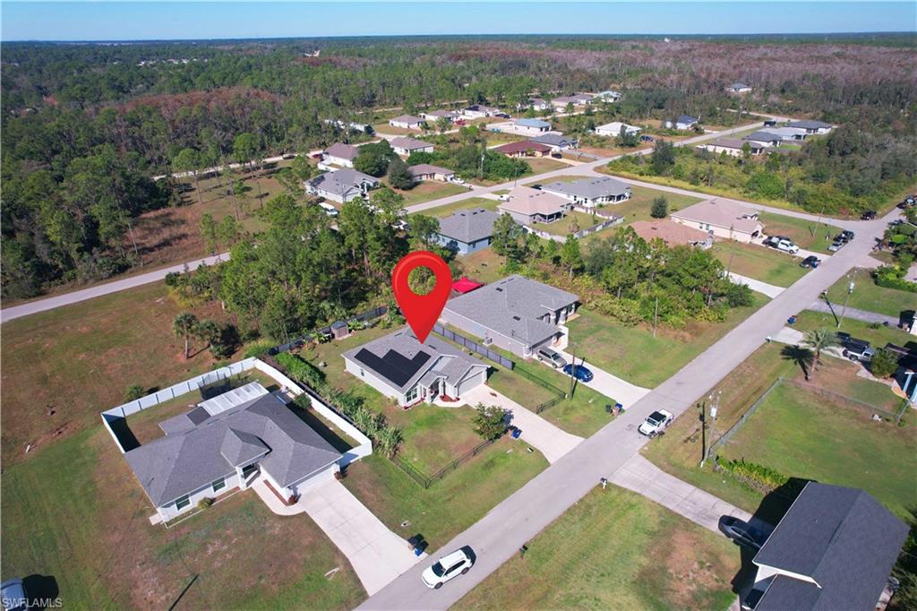 View of property location with nearby suburban area and a forest