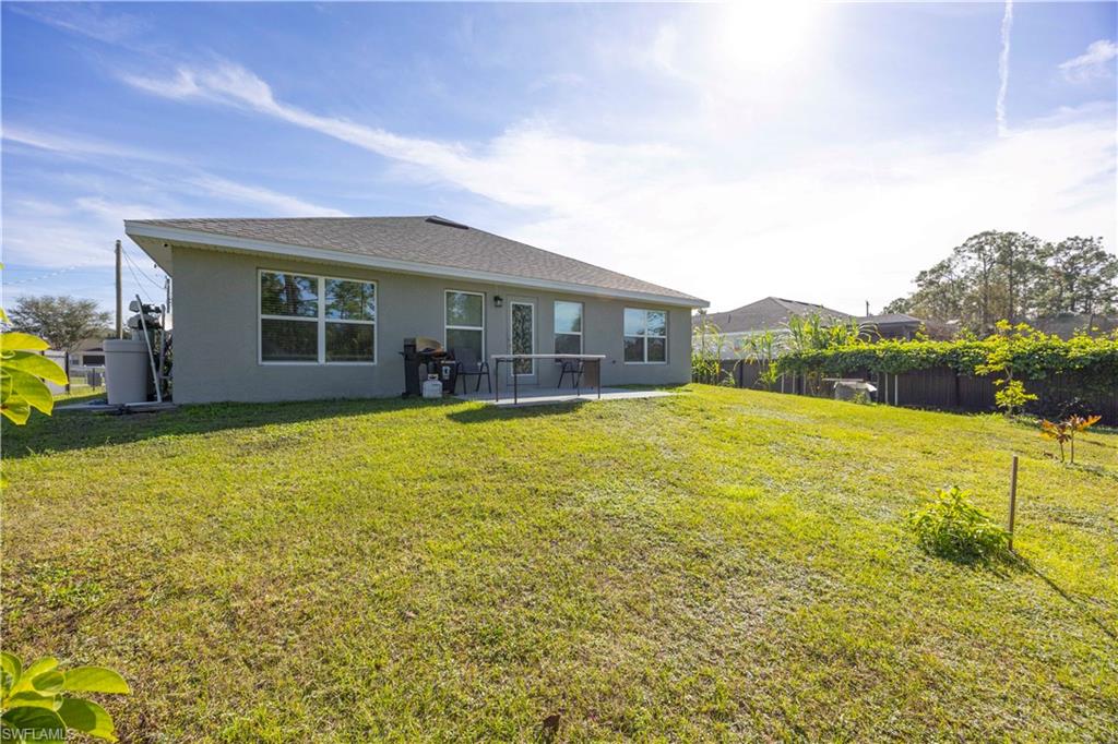 Rear view of property with stucco siding and a patio