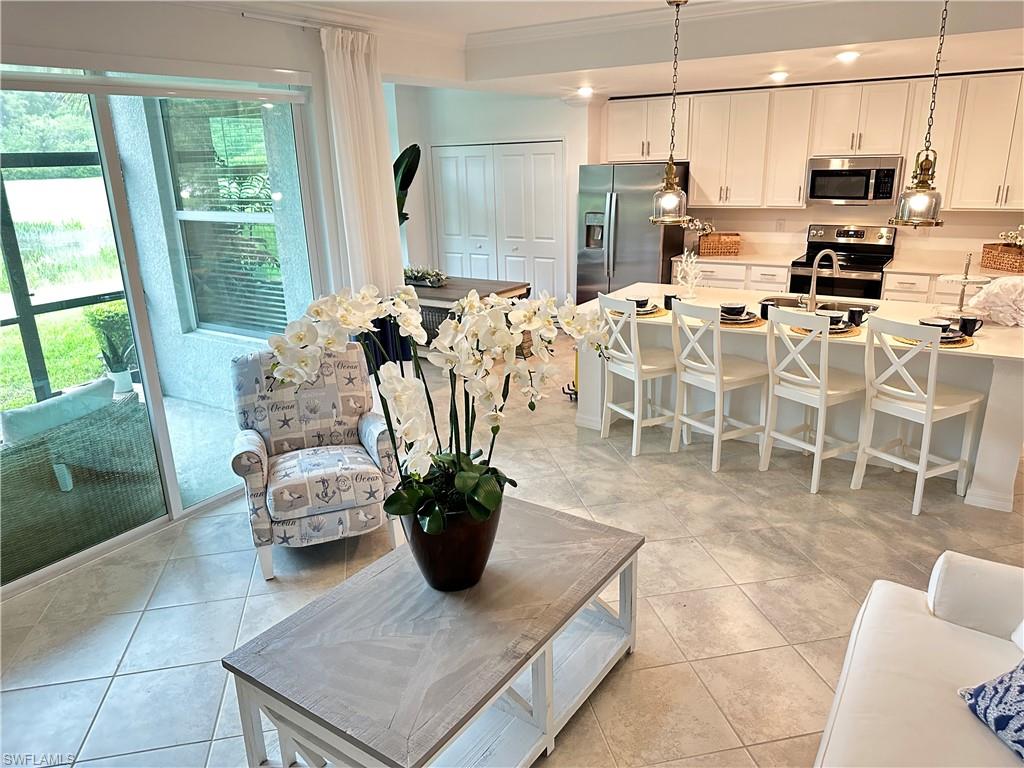 Tiled living room with sink and crown molding