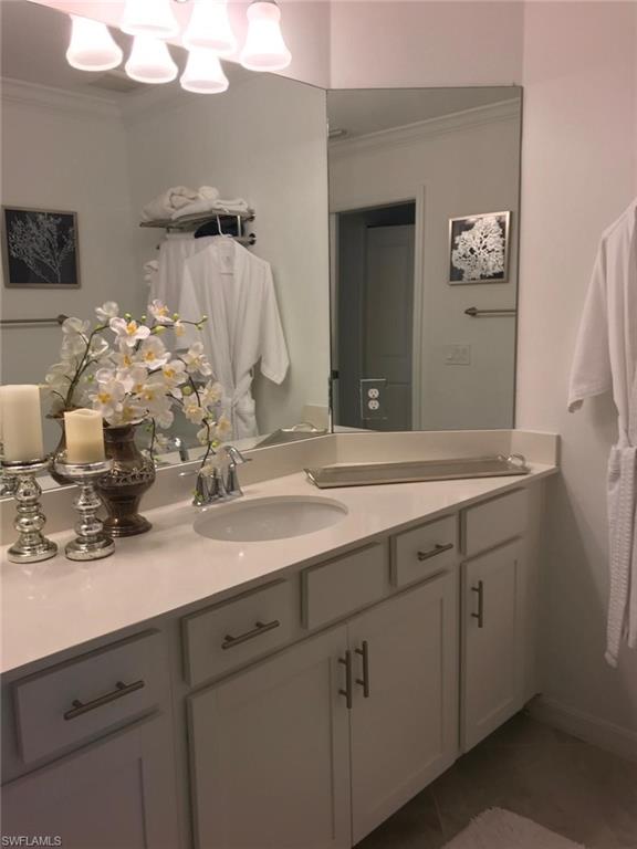 Bathroom featuring vanity and ornamental molding