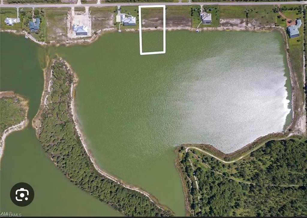 Aerial overview of property's location with a large body of water