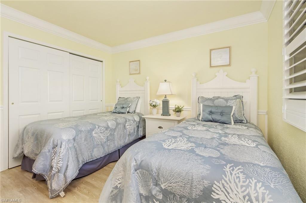 Bedroom featuring a closet, crown molding, and light hardwood / wood-style flooring