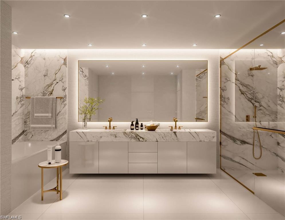 Full bathroom with double vanity, a marble finish shower, stone wall, recessed lighting, and a tub to relax in