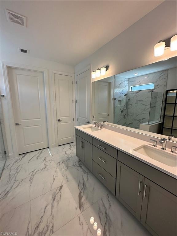 Full bath featuring light marble finish flooring, a marble finish shower, and double vanity