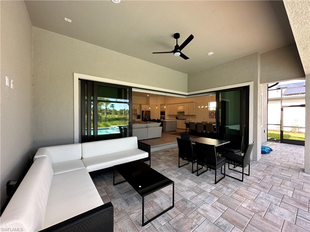 View of patio with an outdoor living space, a ceiling fan, and outdoor dining area