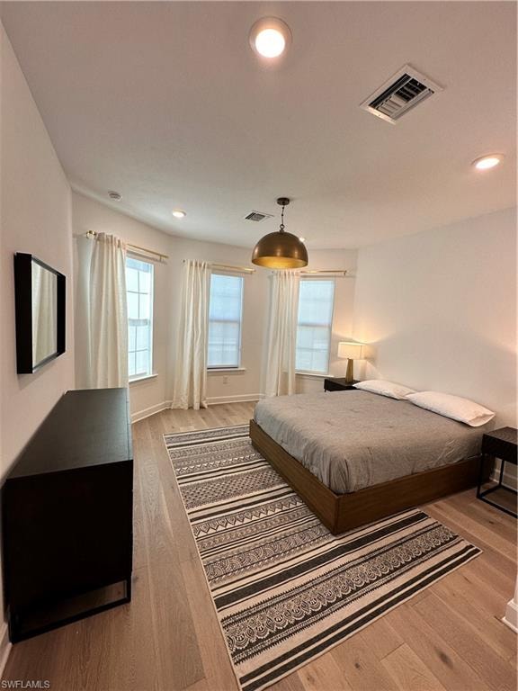 Bedroom with recessed lighting and wood finished floors