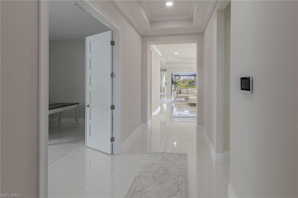 Hall featuring crown molding and tile patterned flooring