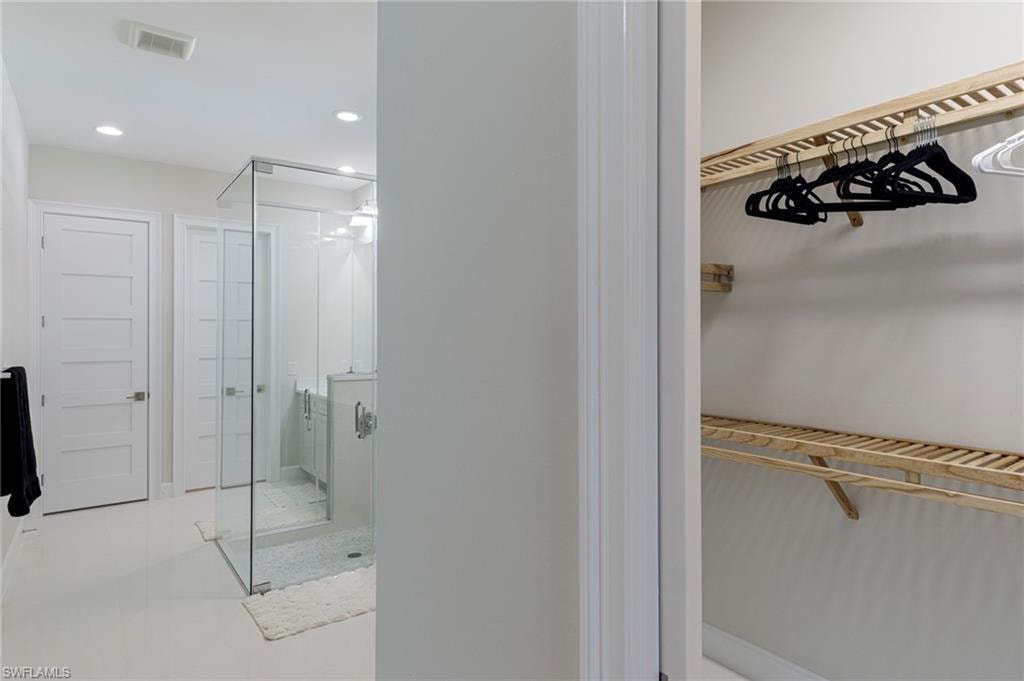 Bathroom featuring a shower with door
