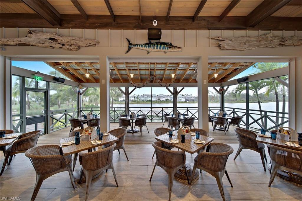 Dining room featuring lofted ceiling with beams, a water view, and wooden ceiling