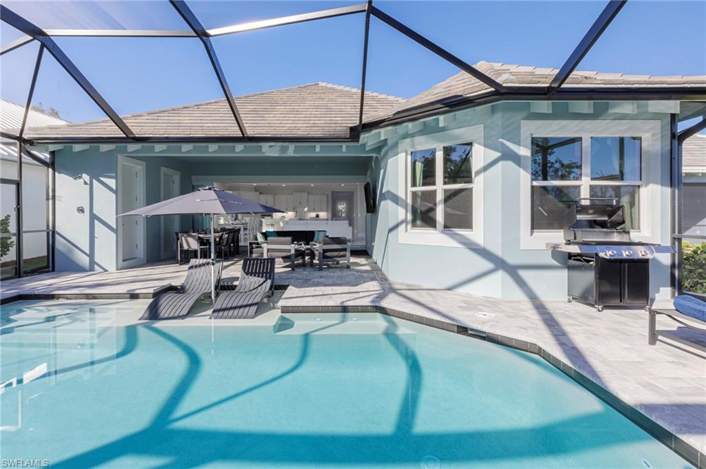 View of pool with a lanai and a patio area