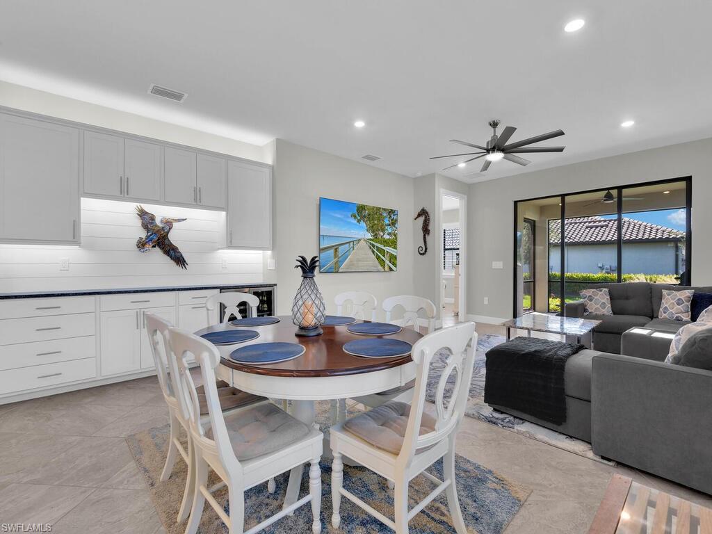 Large open  Dining Area with Built-in additional Bar/Beverage Cabinetry and Beverage Cooler