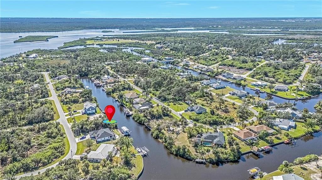 Aerial overview of property's location featuring a large body of water