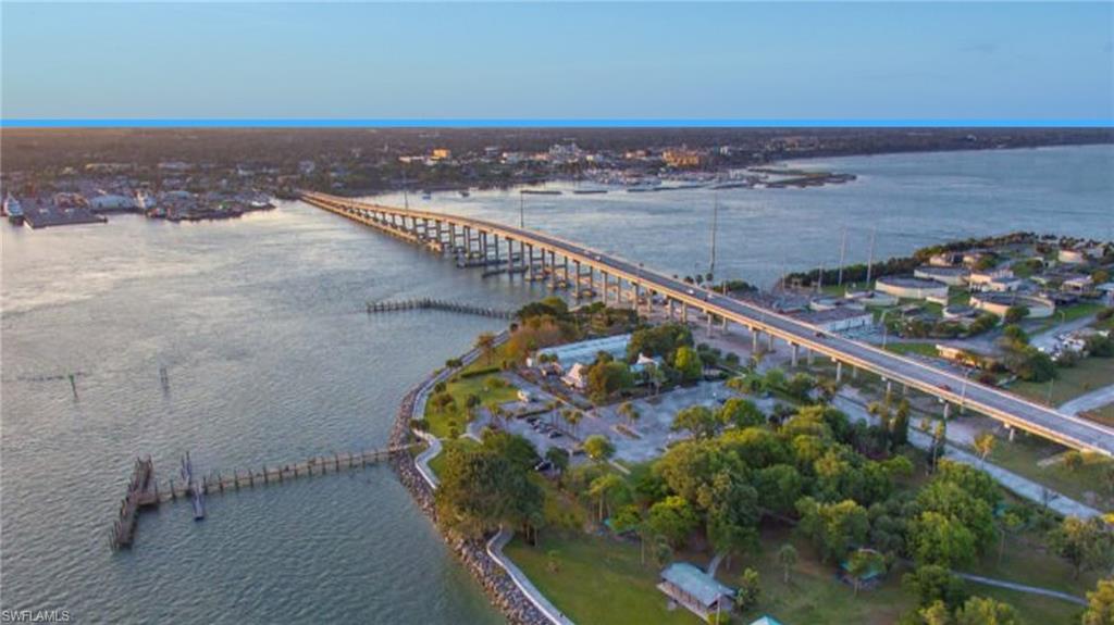 Aerial view of property and surrounding area with a notable bridge and a nearby body of water