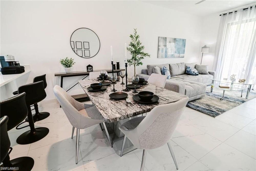 Dining space featuring light tile finish flooring
