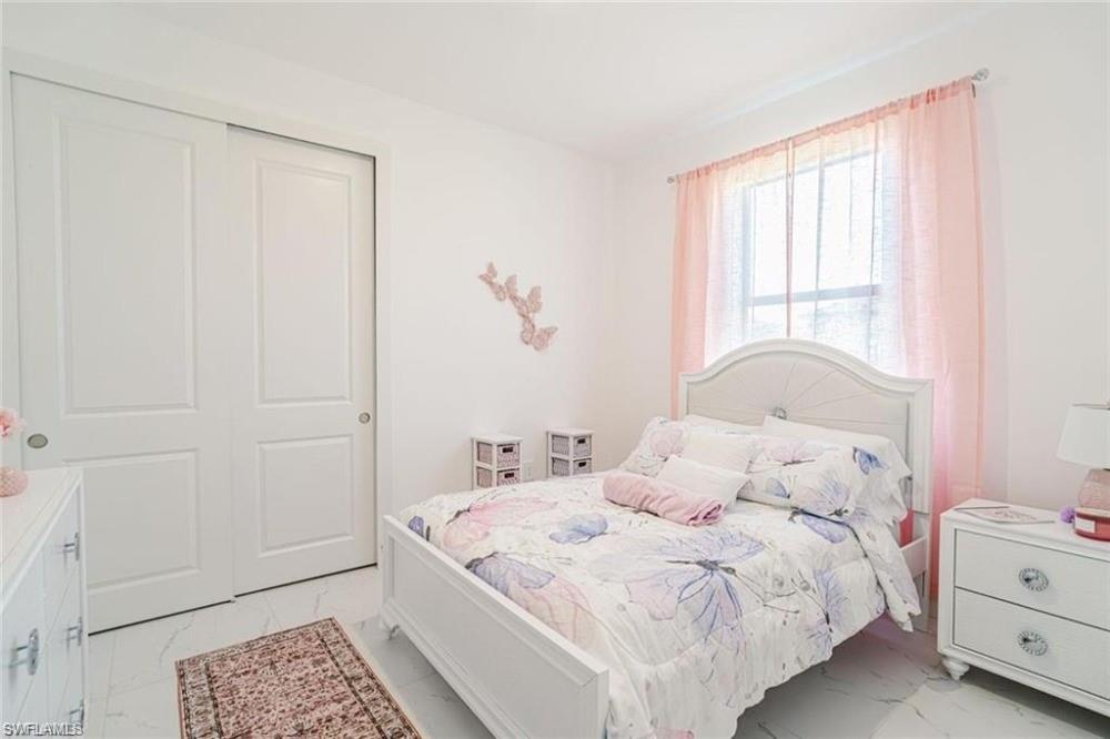 Bedroom featuring light tile finish floors and a closet