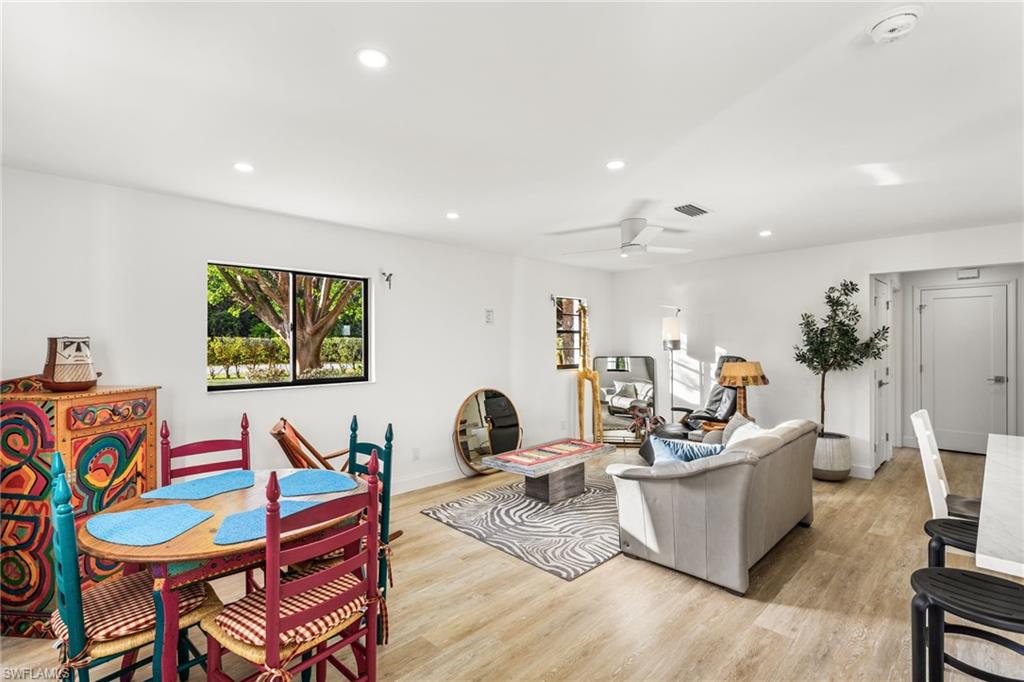 Living area with recessed lighting, light wood-type flooring, and a ceiling fan