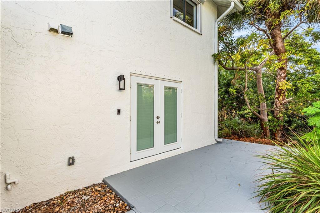 Property entrance featuring a patio area, french doors, and stucco siding