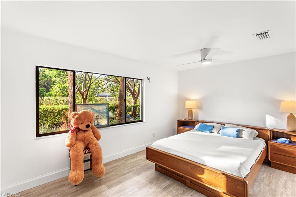 Bedroom with light wood finished floors and ceiling fan