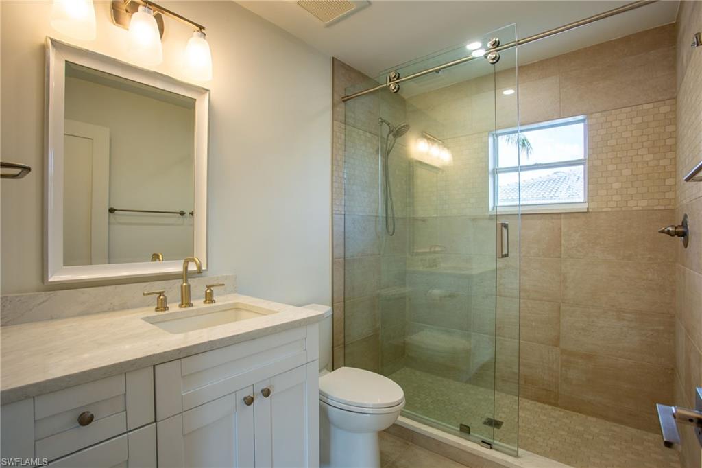 Bathroom featuring vanity and a shower stall