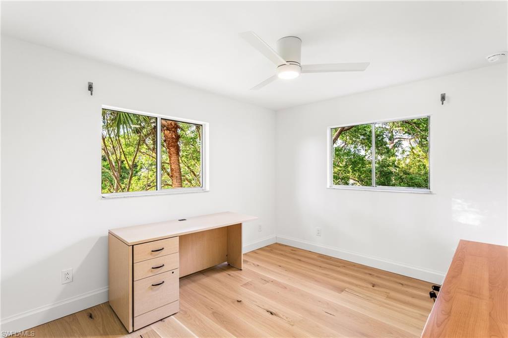 Office or second bedroom featuring light wood flooring, healthy amount of natural light, and a ceiling fan