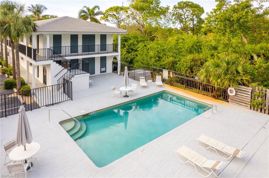 Community pool with stairway, a patio, and a balcony