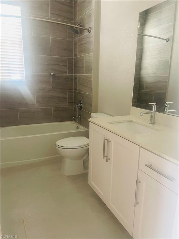 Bathroom featuring vanity, washtub / shower combination, and light tile patterned floors