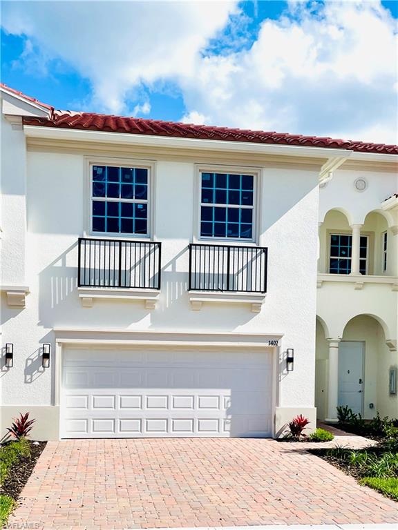 Mediterranean / spanish-style house featuring a balcony, a garage, a tiled roof, and stucco siding