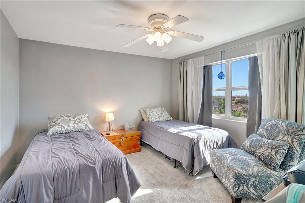 Guest Bedroom with carpet, ceiling fan and nice city view.