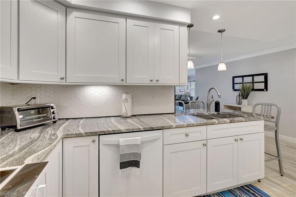 Kitchen featuring corner cabinet, lazy susan, and dishwasher.