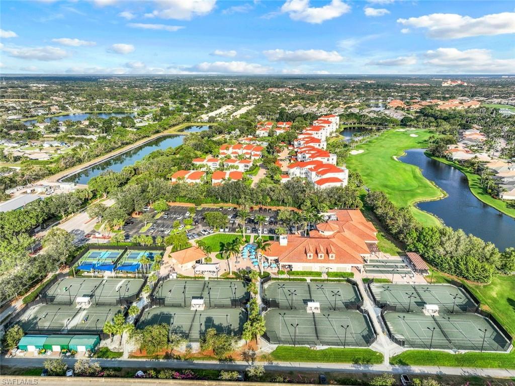 View of property location with a large body of water, nearby suburban area, and a golf course