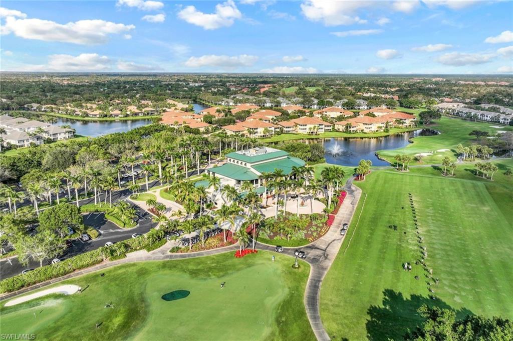 Aerial view of property's location featuring a local golf course, a nearby body of water, and nearby suburban area