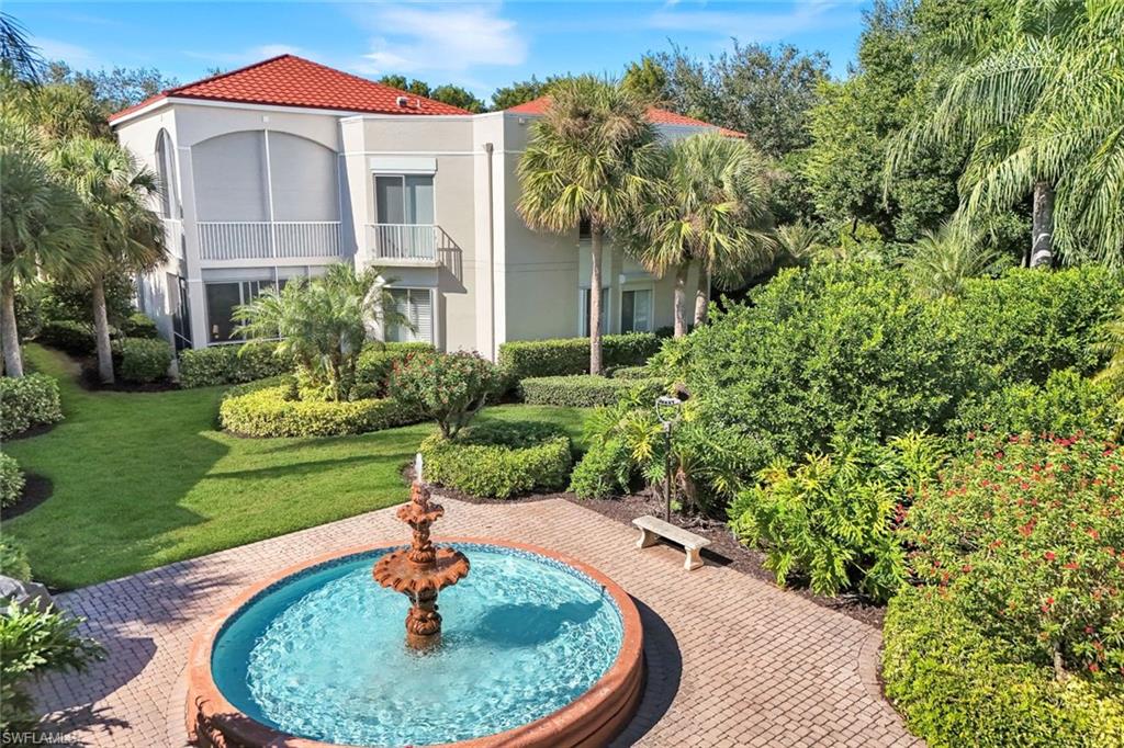 View of property's community featuring a balcony and a lawn