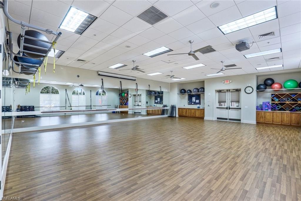 Exercise area with a drop ceiling and ceiling fan